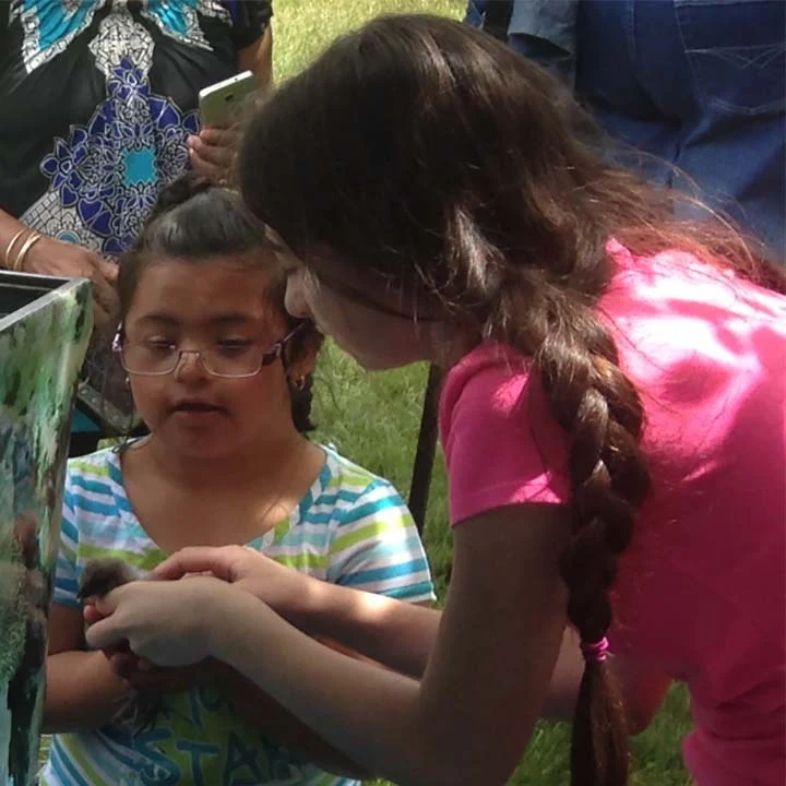 Victoria helping a child meet an animal