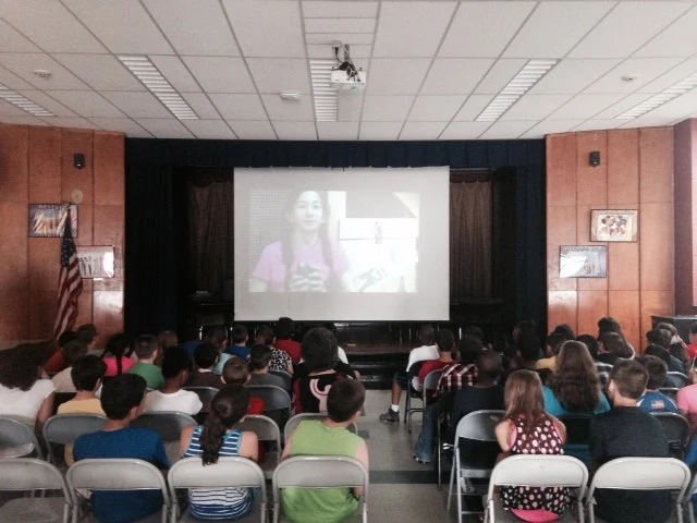 Students watching the original Victoria's Amazing Pets video during an early presentation