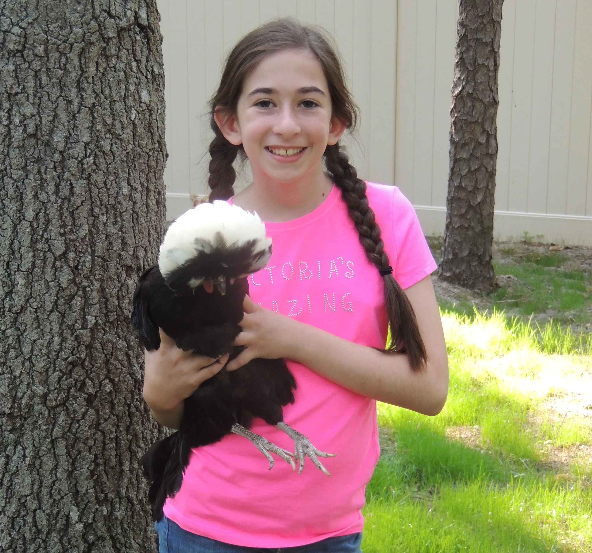 Young Victoria holding an exotic chicken