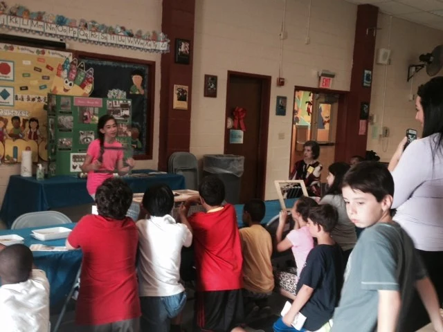 Victoria presenting Victoria's Amazing Pets to students in a classroom