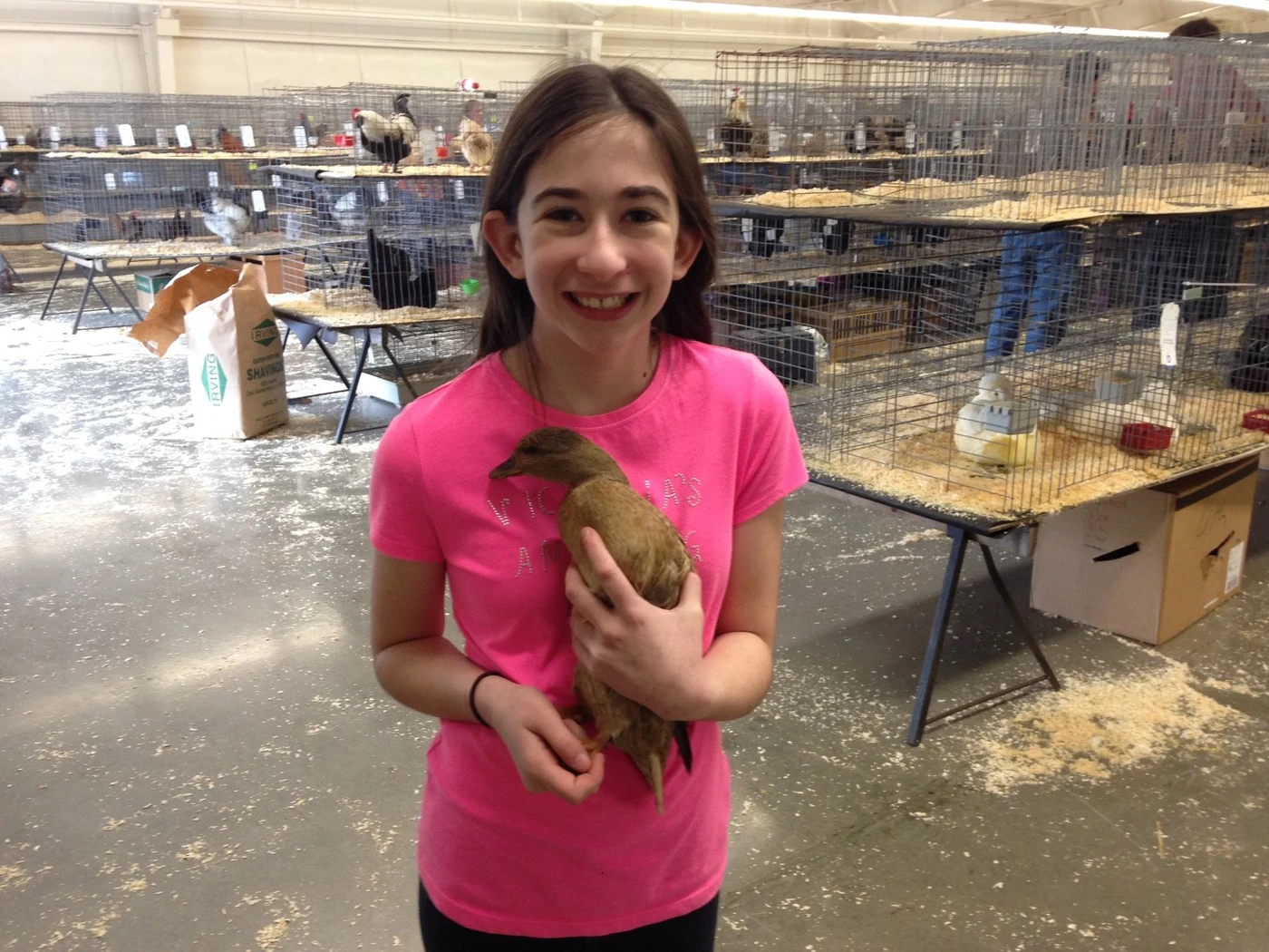 Victoria holding a bird at the Northeastern Poultry Congress