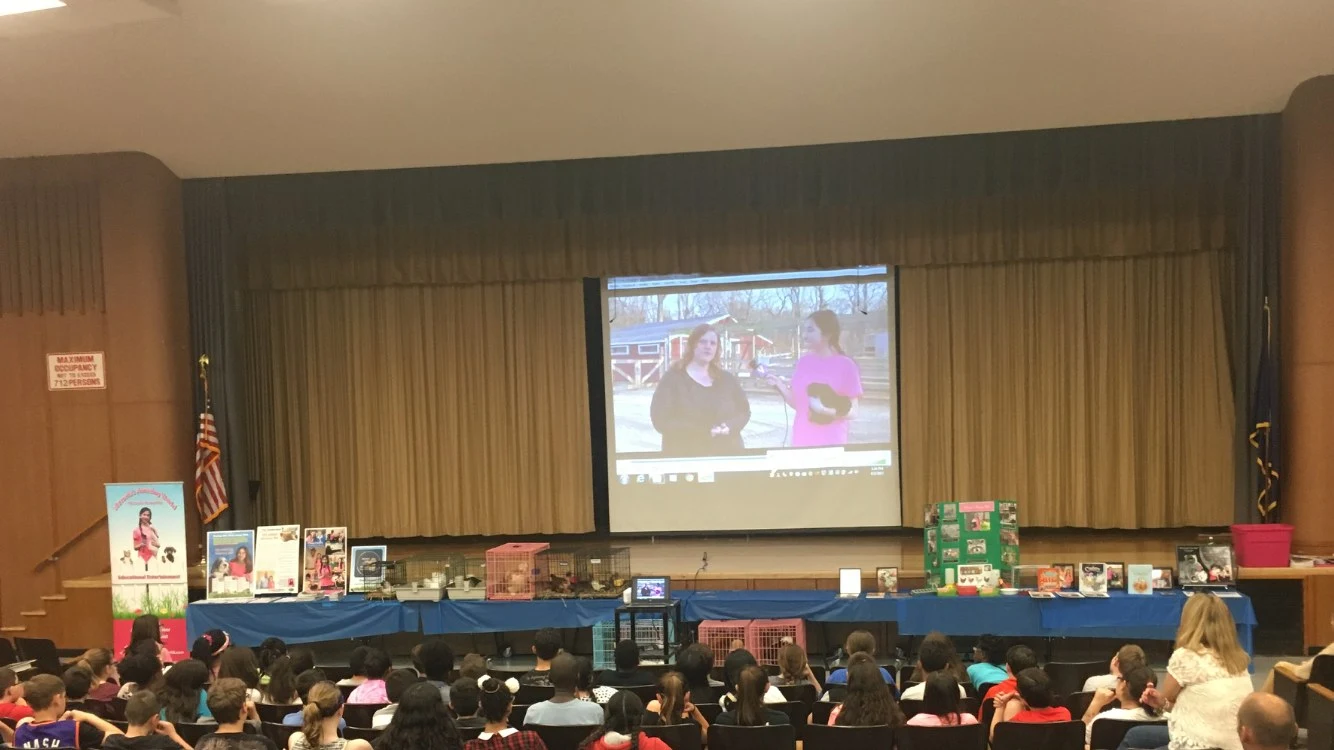 Victoria's Amazing Pets school presentation with video screen and animals