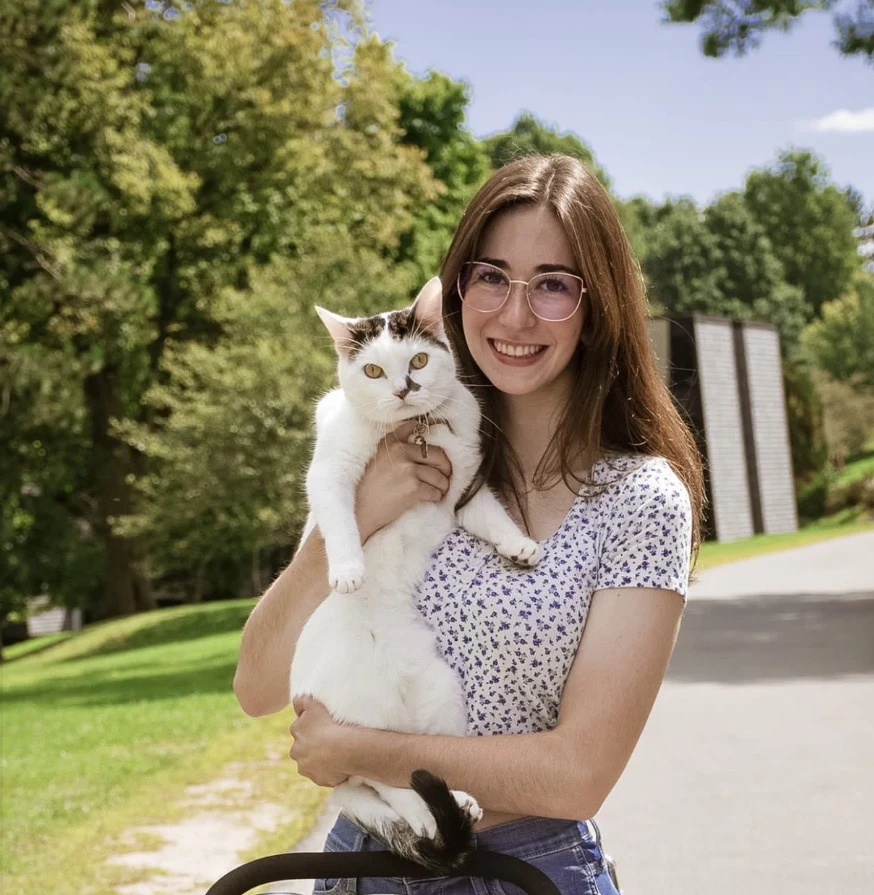 Victoria holding a cat outdoors
