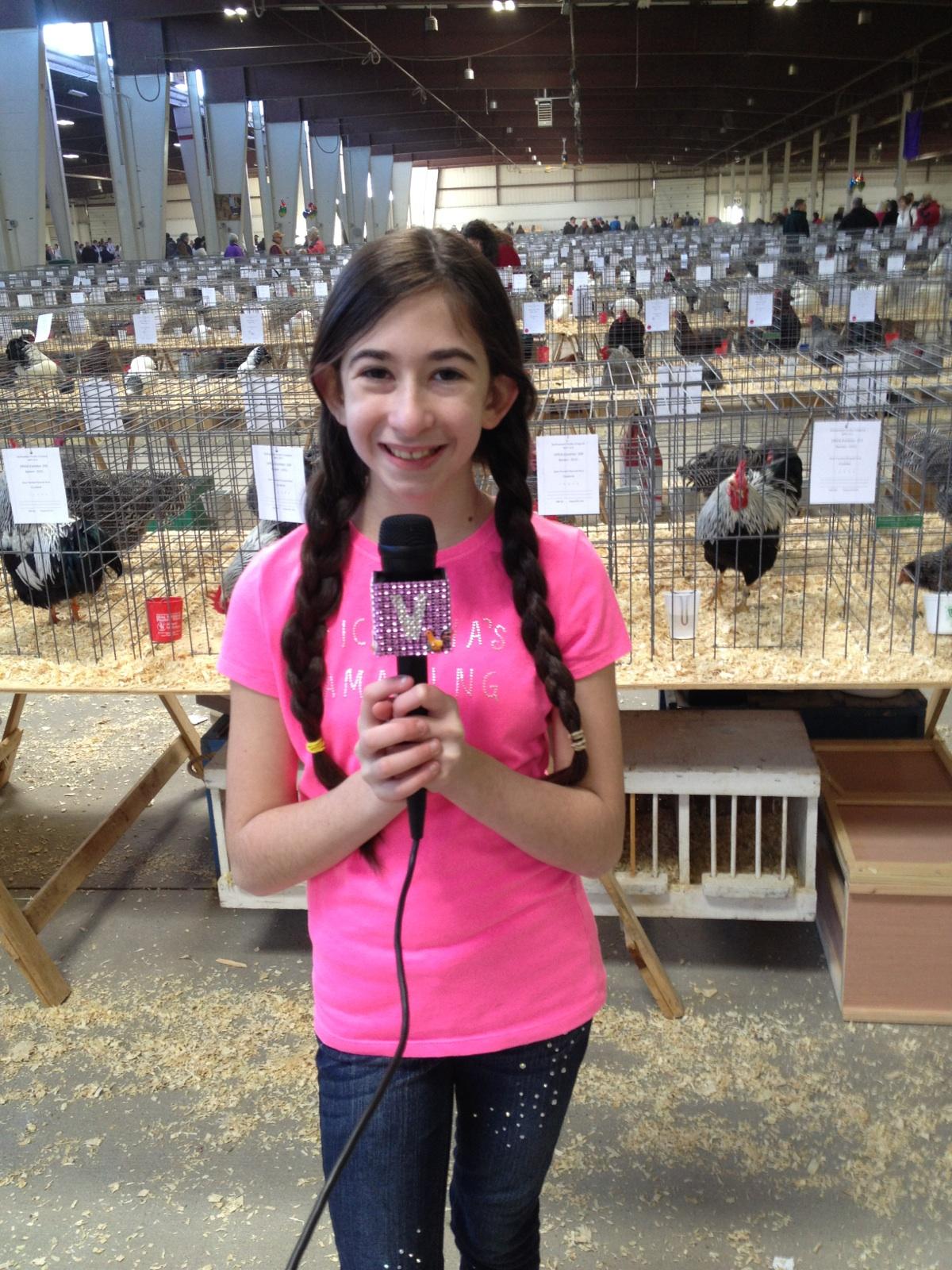 Victoria holding a bird at a poultry event