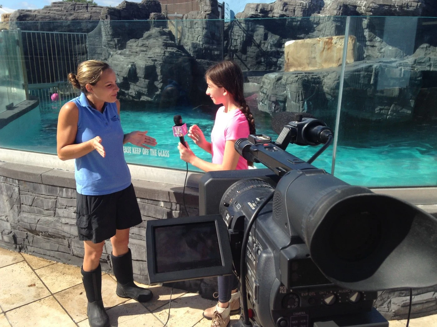 Victoria filming an interview at the Long Island Aquarium