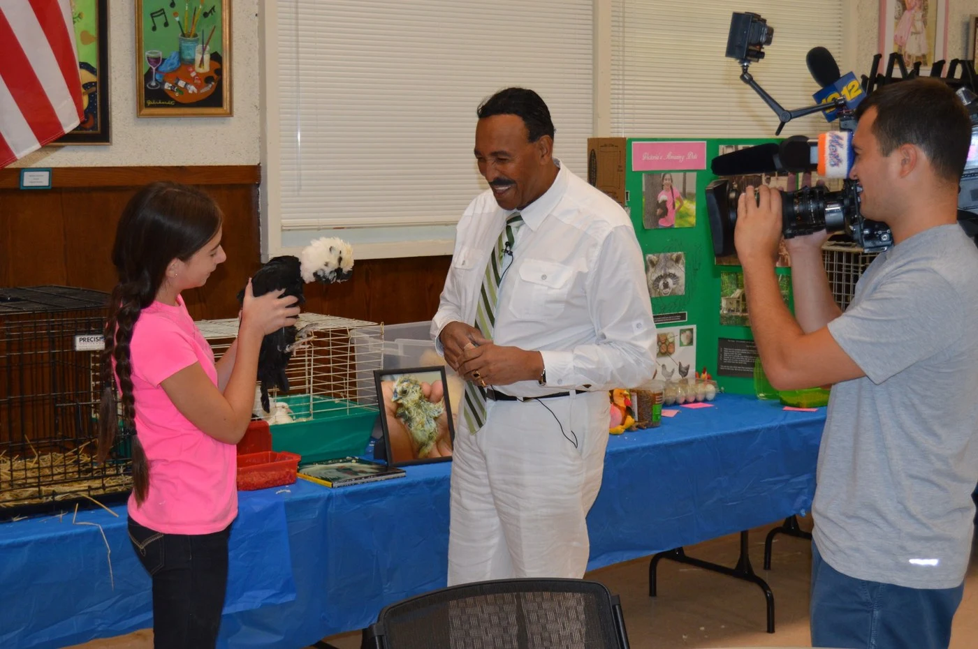 Victoria being filmed for television news during a senior center program
