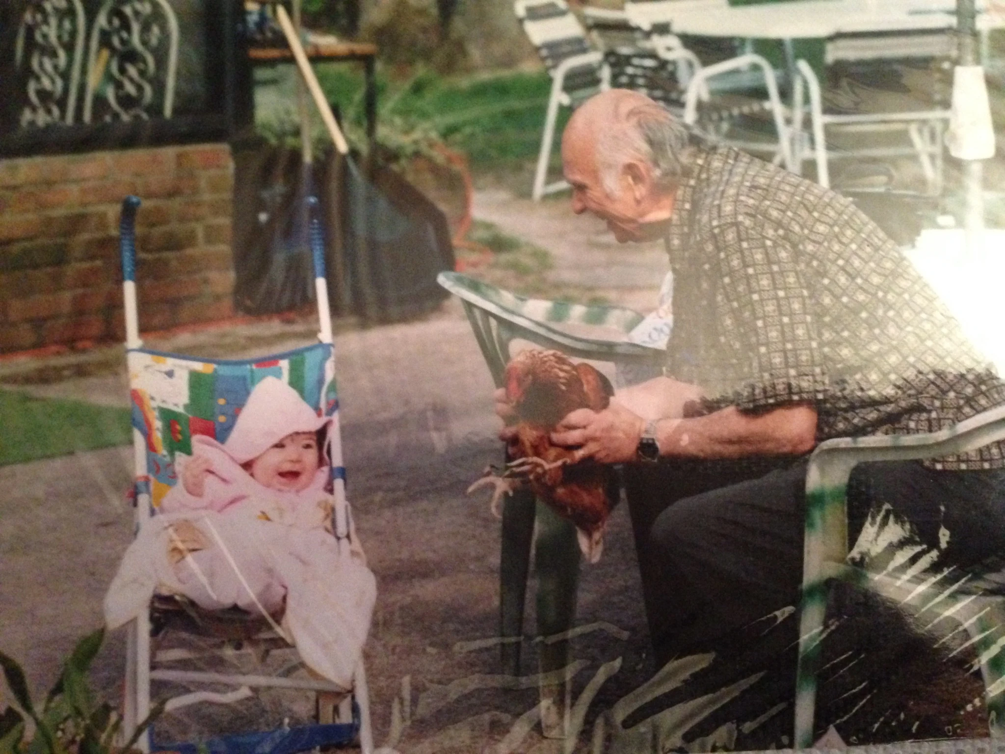 Baby Victoria with her grandfather and a chicken