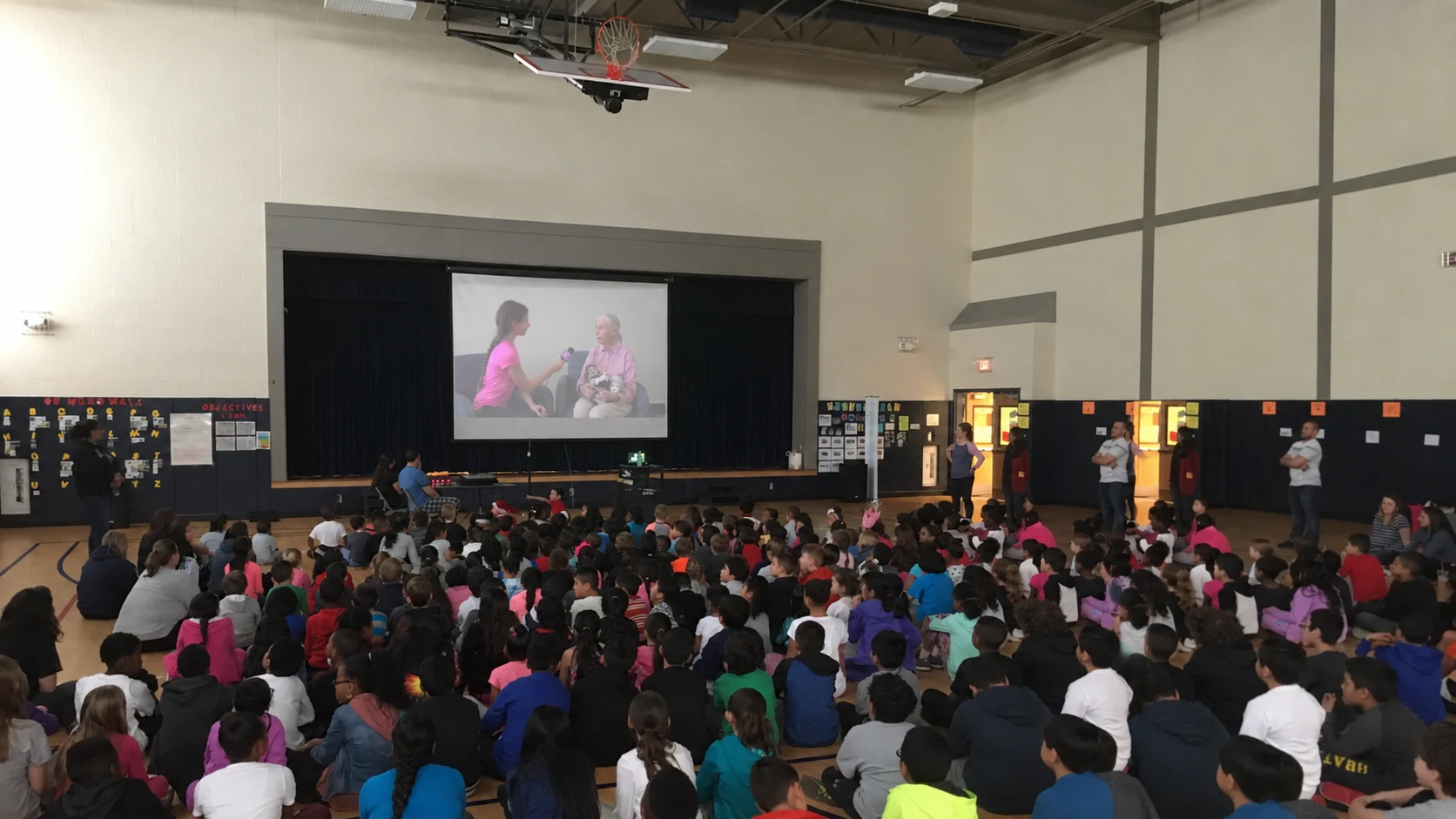 Students watching Victoria’s interview with Dr. Jane Goodall during a school assembly